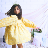 Pinkcow Fashions yellow floral print party and birthday wear babydoll dress with gathered waist and ruffled bishop sleeves long sleeves yellow