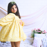 Pinkcow Fashions yellow floral print party and birthday wear babydoll dress with gathered waist and ruffled bishop sleeves long sleeves yellow