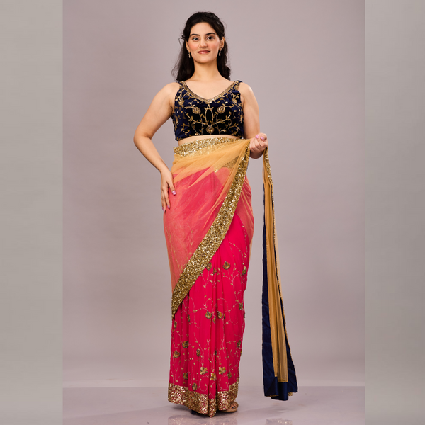 A vibrant pink and beige saree with gold sequin border, floral embroidery, and a contrasting navy blue blouse