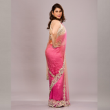 gracefully draped in a pink and orange shaded net saree with ornate white and gold embroidery