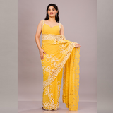 A vibrant yellow saree with intricate white embroidery and lace detailing