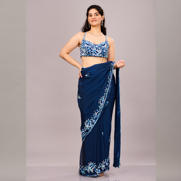 Navy blue sequined georgette saree with a sleeveless blouse