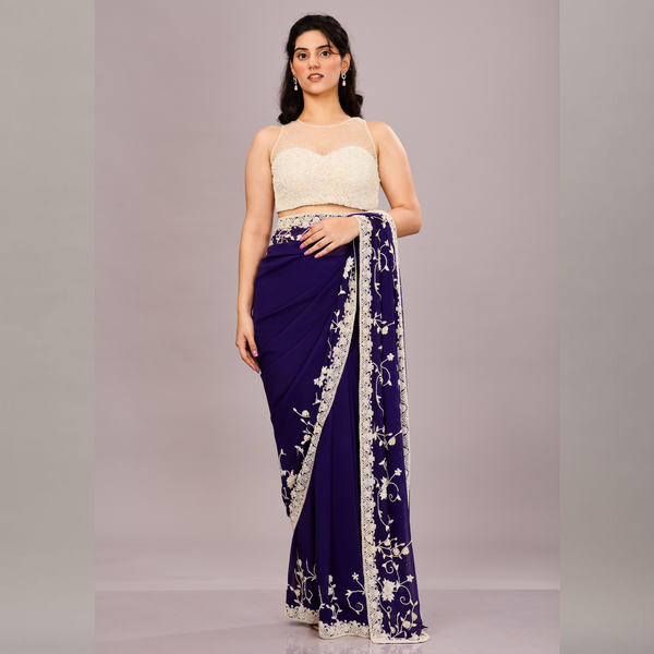 A georgette saree adorned with intricate white floral embroidery along the border and pallu